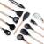 Black silicone kitchen tools with wooden handles