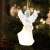 LED angel Christmas ornament, white, clear, with wings, holding a musical instrument, on a Christmas tree