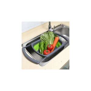 Green and gray foldable silicone strainer in use, washing vegetables in a sink - Strainer & Sieve