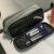 Gray pencil case with three compartments on a desk