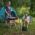 Navaris folding camping table with adjustable legs, used by a couple in a camping setting