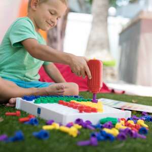 Child playing with the Educational Insights Activity Center toy drill and board - Educational Insights