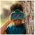 Child using GeoSafari Kidnoculars Extreme binoculars, blue, green, and orange, 5-9 years old