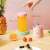 Kerisson Easy Mix Mini Electric Blender, pink, with a glass of orange juice and a description of the features
