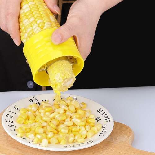Yellow corn cob peeler in use, removing kernels from corn cob