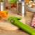 Kuhn Rikon green can opener on a wooden cutting board with peppers and cans