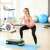 Woman using a step pad for workout in a gym
