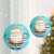 Two blue paper Christmas lanterns with Santa Claus design, 25 cm diameter, hanging on a Christmas tree