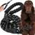 Black and white rope dog leash with padded handle, dog in the background