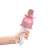 Hand holding NeoHGS pink wireless karaoke microphone for kids
