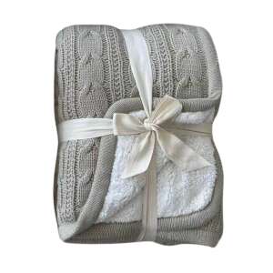 Halványbarna kötött takaró fehér sherpa béléssel, fehér szalaggal átkötve - Pléd