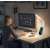 Woman working at a desk with a computer, using the SML TX 75 LED desk lamp with wireless charging