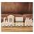 White wooden Christmas train with Santa Claus, a house and a carriage, with warm white LED lights, on a wooden table