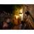 Philips Hue outdoor motion sensor, black, mounted on a brick wall, with people in the background