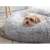 Grey plush dog bed with a small dog lying in it