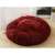 Red plush dog bed on a wooden floor