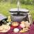 Navaris insulated picnic basket with handle, being used for a picnic, 27 liters capacity, black
