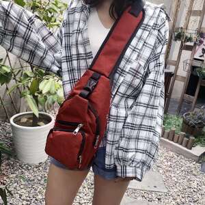 Red chest bag worn by a woman, perfect for carrying a tablet and other essentials - Dressing Accessory