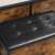 Close-up of the black faux leather top of the rustic brown storage bench with metal frame