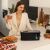 Woman enjoying breakfast with Cecotec Toast&Taste Extra B Black Toaster
