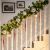 Flippy Galamb Christmas string lights decorating a staircase with garland and ornaments