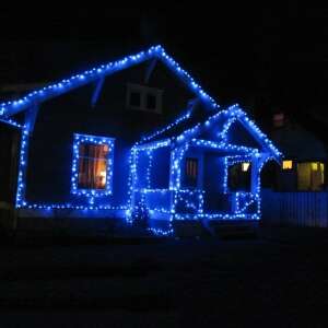 Blue Christmas lights decorating a house exterior - Home & Garden