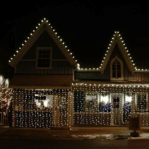 Flippy Christmas curtain lights decorating a house exterior - Home & Garden