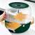 Flippy 360 degree rotating cereal dispenser with 6 compartments, dark green, with arrows showing the rotation