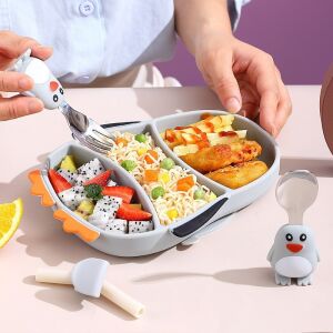 Flippy Penguin silicone baby dinnerware set in use, divided plate, fork and spoon - Children's dinnerware set