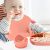 Flippy Baba 5-piece pink silicone baby feeding set in use with baby
