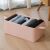 KipHome pink faux leather storage box with clothes on floor