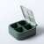 Open green Mini Candy Pill Box with 4 compartments, portable, airtight, for travel, medicine storage