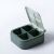 Open green Flippy mini pill box with 4 compartments