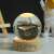 Flippy LED night light with whale design, crystal ball with wooden base, warm white light, in use