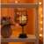 Flippy wine glass shaped LED table lamp with warm white light on a shelf