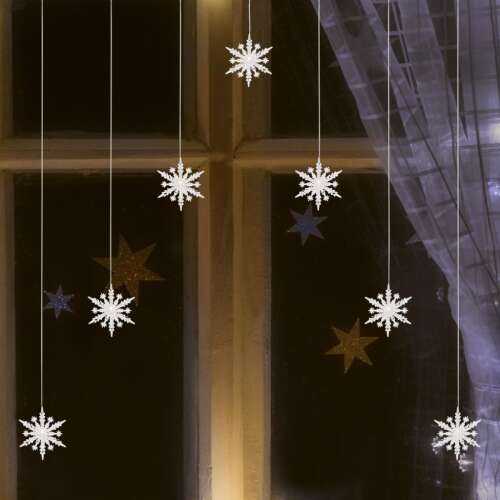 Home KAF7WW snowflake light curtain with 7 warm white LEDs hanging in a window
