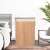 Bamboo laundry hamper in a bedroom setting