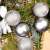 Pepita silver Christmas ornaments on a Christmas tree branch