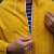 Close-up of the zipper and button closure on the BSP Guard Easy Fit yellow raincoat