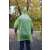 BSP Guard Poncho Raincoat, green color, worn by a man in a park
