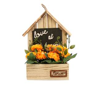 Wooden house shaped flower arrangement with orange artificial flowers, 'Love at Home' sign, and 'Flower' label - Artificial Plant & Flower