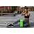 Woman using a green EVA foam fitness roller for leg muscle recovery outdoors, Neo-Sport NS-963