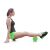 Woman using green EVA foam roller for leg exercise