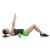 Woman using green EVA foam roller for back exercise