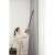 Woman using Dreame T30 cordless stick vacuum cleaner to clean curtains