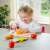 Child playing with New Classic Toys Cutting Meal wooden play food set