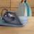 Electrolux E6SI1-4MN steam iron on a table with a shirt