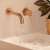 Rea Lungo Cooper Brush wall mounted bathroom faucet in use, gold finish