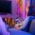 Lumini LED Twinkly Candies RGB+W decorând un perete din living, controlate printr-o aplicație de pe smartphone