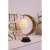 TWIRL STAR crescent moon table lamp with a white rattan ball, black metal base, on a table with a book